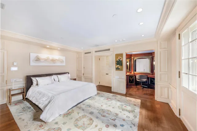 a bedroom with a bed and a television