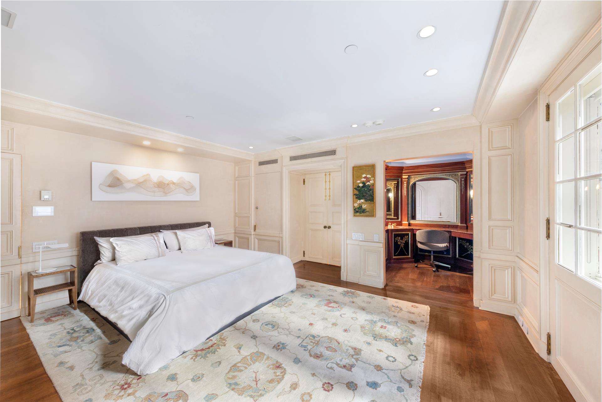 160 Central Park South, Unit 915 Manhattan, NY 10019 - Photo 5 of 18 a bedroom with a large bed and a large window