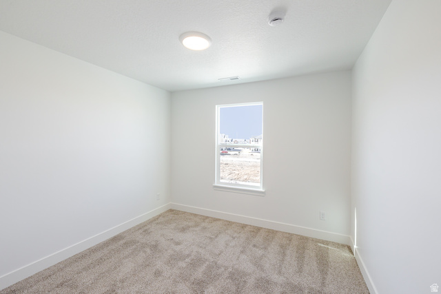 4809 Olive Avenue, Unit 417 Mapleton, UT 84664 - Photo 15 of 18 Unfurnished room featuring light carpet and a smoke detector