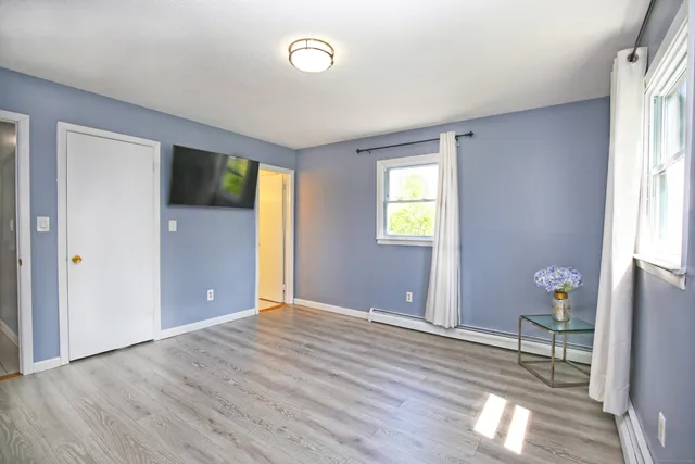 a bedroom with a bed and a television