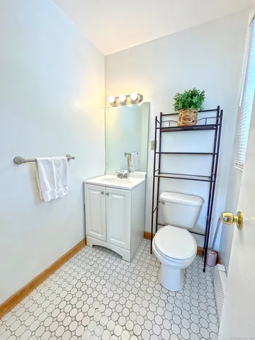 a bathroom with a sink a toilet a mirror and shower