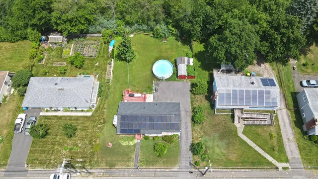 an aerial view of a house with a swimming pool