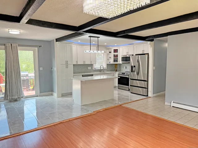 a bedroom with a bed a dresser and a window