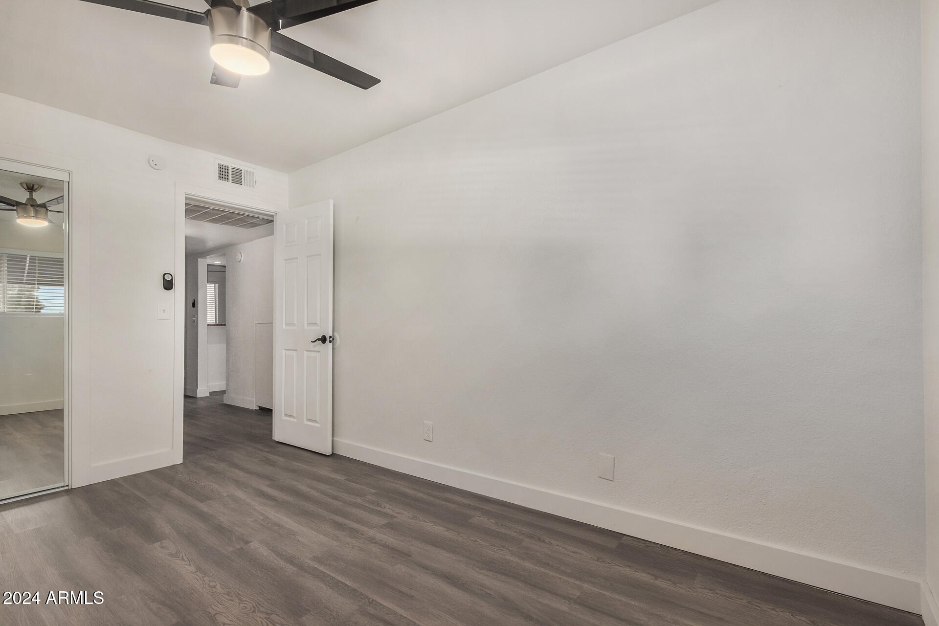 18202 Cave Creek Road, Unit 251 Phoenix, AZ 85032 - Photo 11 of 20 a view of an empty room with wooden floor