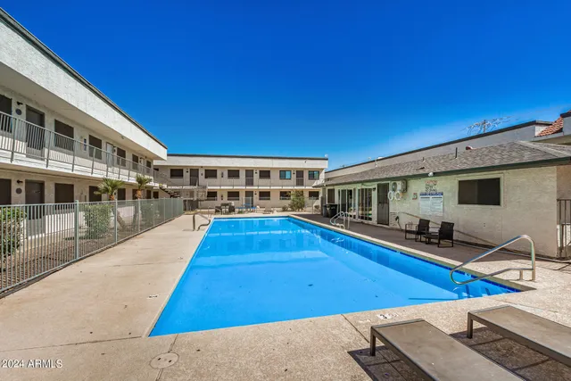 a view of a swimming pool with two chairs and a table