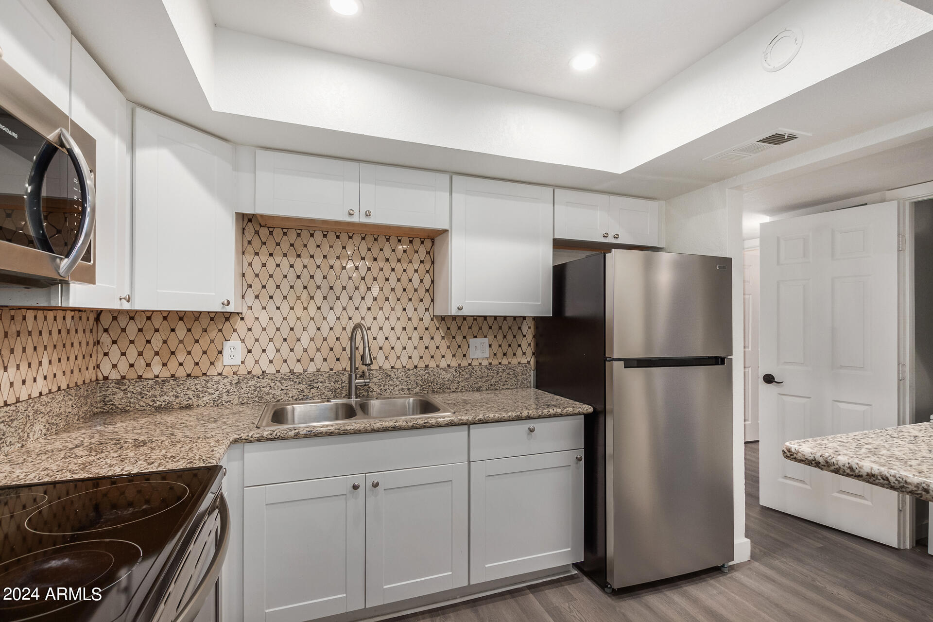 18202 Cave Creek Road, Unit 251 Phoenix, AZ 85032 - Photo 8 of 20 a kitchen with a refrigerator sink and cabinets