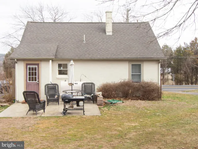 a backyard of a house with yard and outdoor seating
