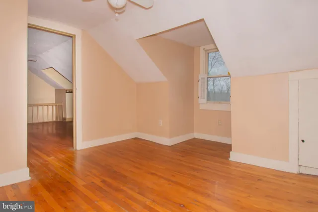 a view of hallway with wooden floor and stairs