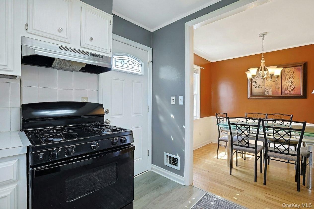 43 John Alden Road New Rochelle, NY 10801 - Photo 16 of 28 a kitchen with stainless steel appliances a stove a microwave and cabinets