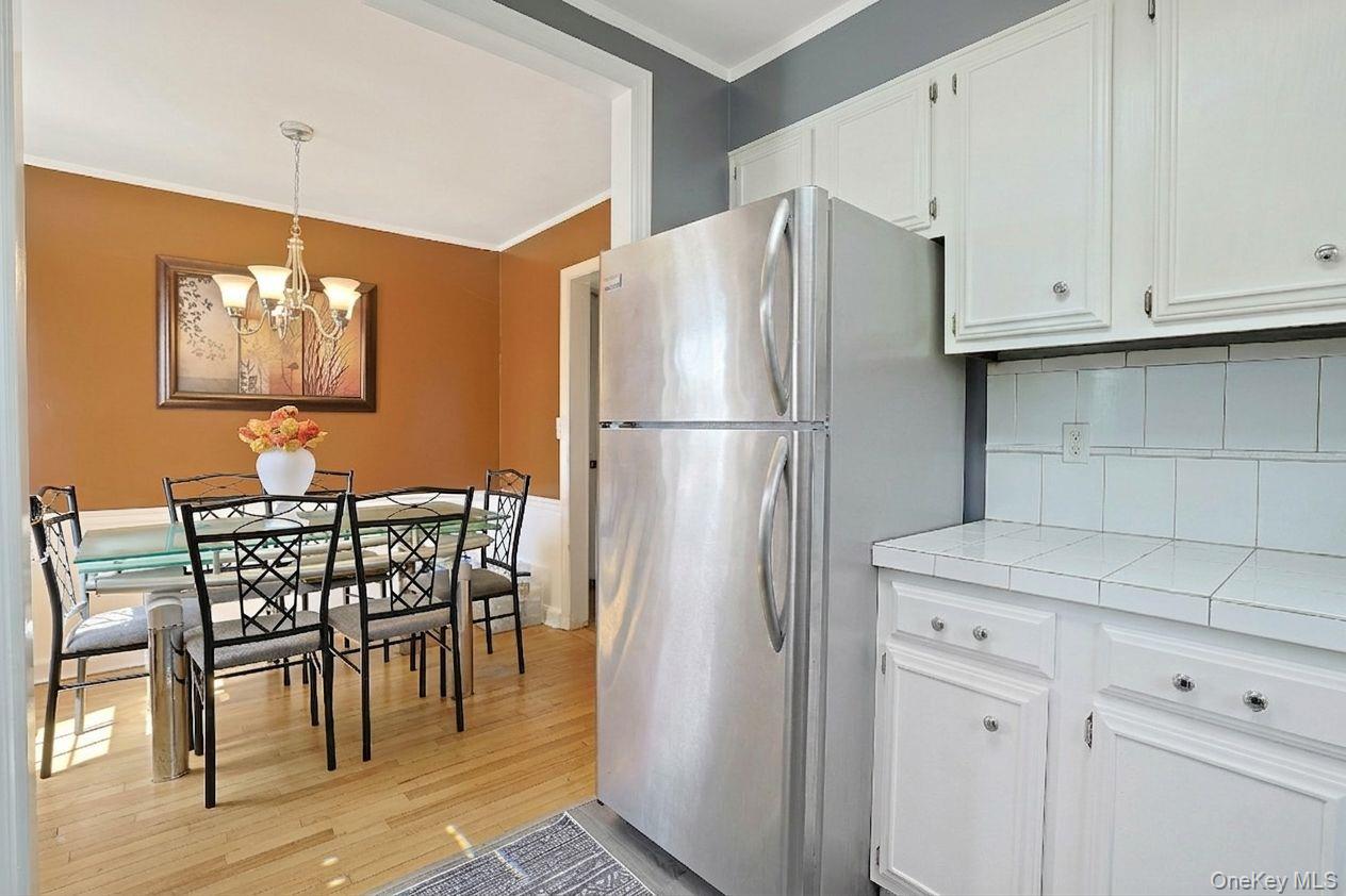 43 John Alden Road New Rochelle, NY 10801 - Photo 17 of 28 a white refrigerator freezer sitting in a kitchen with stainless steel appliances granite countertop furniture and a refrigerator