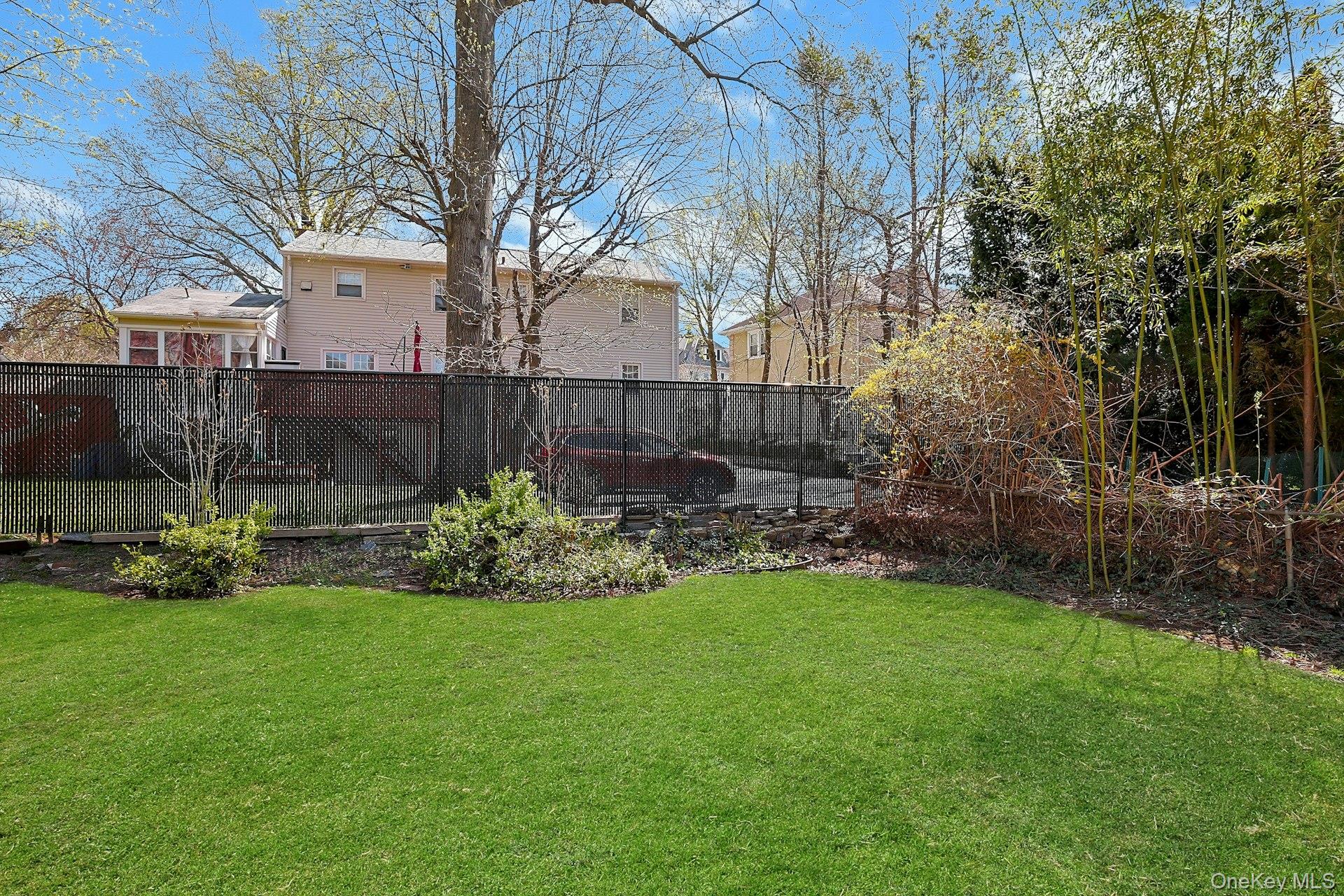 43 John Alden Road New Rochelle, NY 10801 - Photo 24 of 28 a view of a garden with a bench