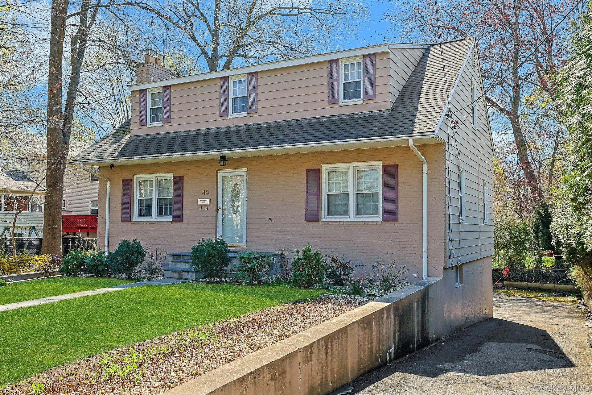 43 John Alden Road New Rochelle, NY 10801 - Photo 3 of 28 a front view of a house with garden