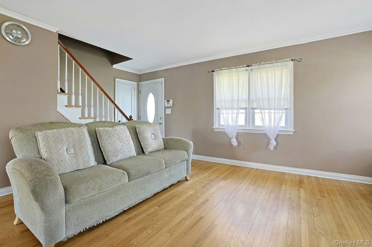 43 John Alden Road New Rochelle, NY 10801 - Photo 4 of 28 a living room with a couch and a window