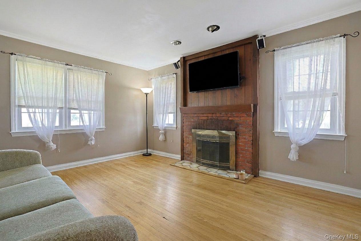 43 John Alden Road New Rochelle, NY 10801 - Photo 9 of 28 a living room with a flat screen tv and a fireplace