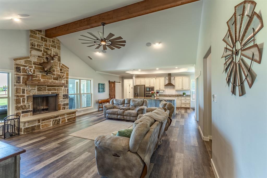 14910 Old Stoney Road Ponder, TX 76259 - Photo 14 of 36 a living room with furniture a fireplace and a chandelier