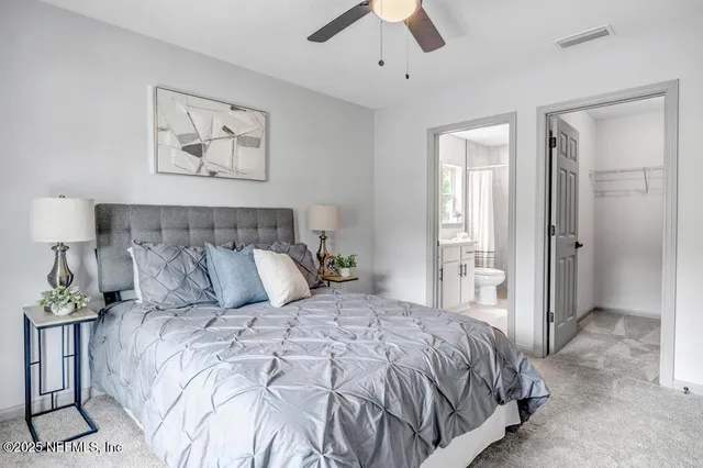 a bedroom with a large bed and a chandelier