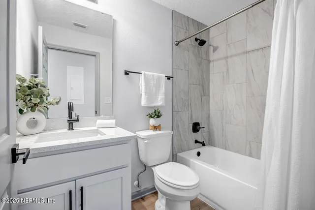 a bathroom with a sink toilet and shower
