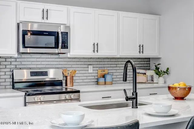 a kitchen with a stove and a microwave