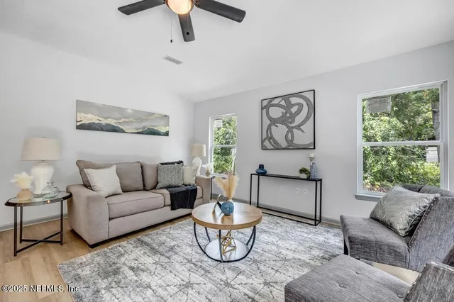 a living room with furniture and a large window