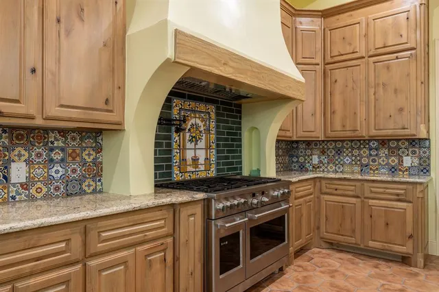 a kitchen with stainless steel appliances granite countertop a stove and a sink
