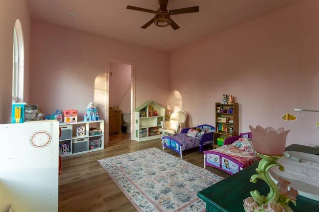 a bathroom with a granite countertop sink a toilet and shower