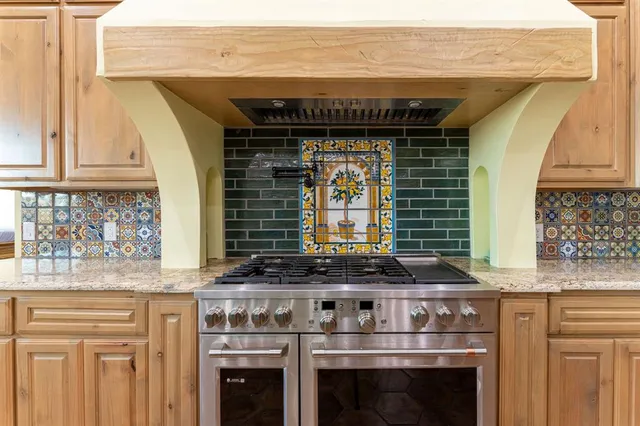a kitchen with stainless steel appliances granite countertop a stove and a sink