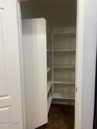 an empty room with windows and ceiling fan