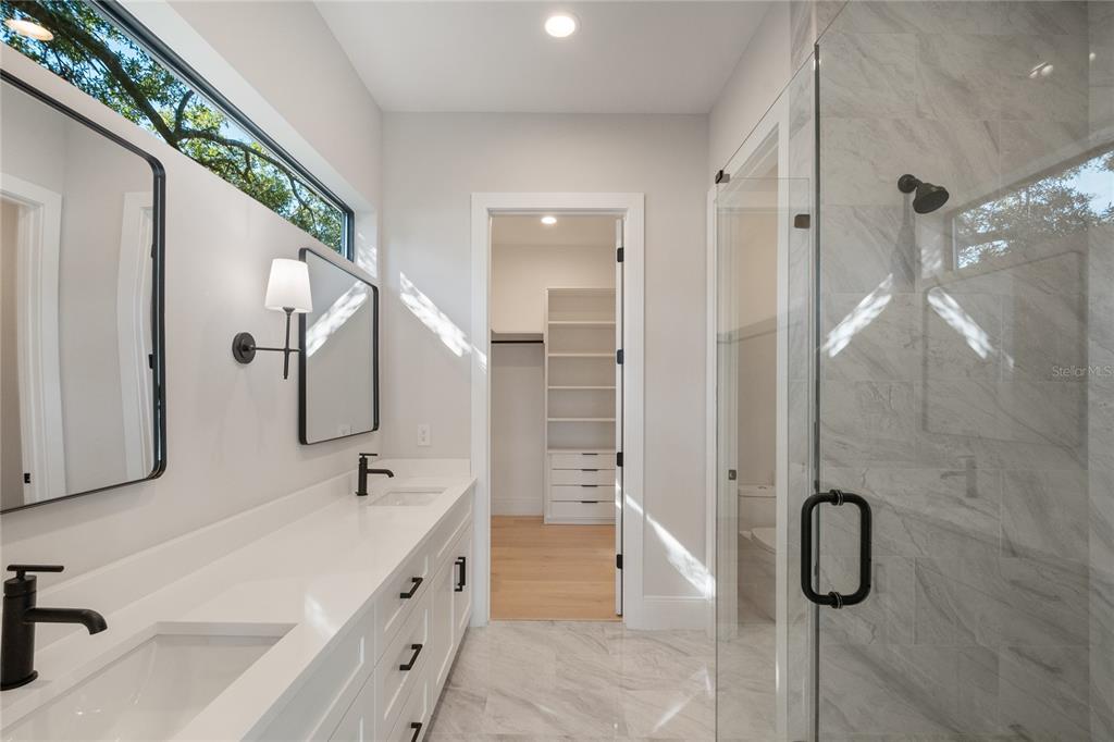 1751 Glencoe Road Winter Park, FL 32789 - Photo 28 of 45 a spacious bathroom with a granite countertop sink mirror and shower