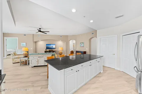 a kitchen with stainless steel appliances granite countertop a sink a stove and a refrigerator
