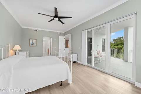 a spacious bedroom with a bed and a large window