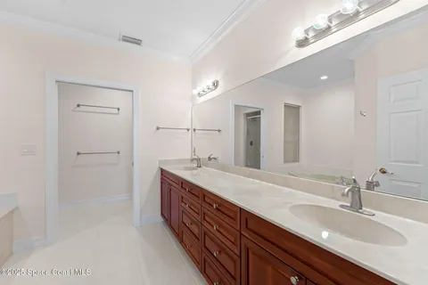 a spacious bathroom with a granite countertop sink a mirror and a shower