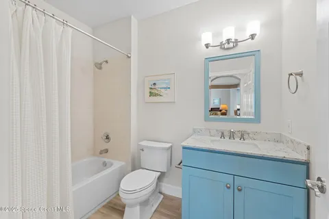 a bathroom with a sink toilet a mirror and shower