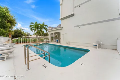 a swimming pool with outdoor seating and yard