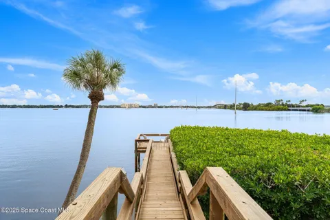 a view of a lake with couches in the patio