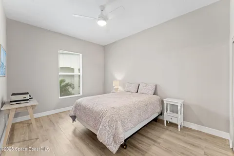 a bedroom with a bed lamps and window