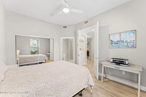 a bedroom with a bed and a large mirror