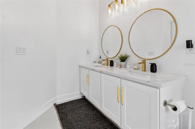 a bathroom with a sink a mirror and a vanity