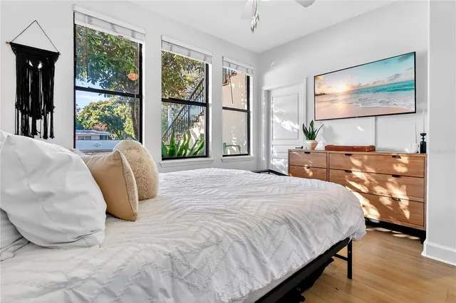 a bedroom with a bed and glass windows