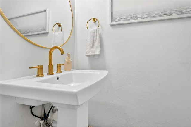 a bathroom with a sink and mirror