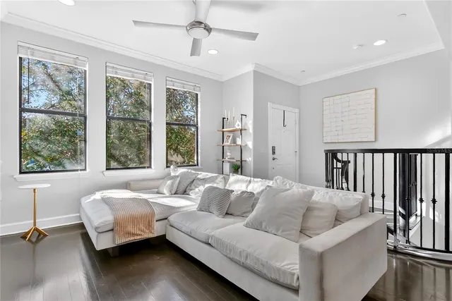 a living room with furniture and windows