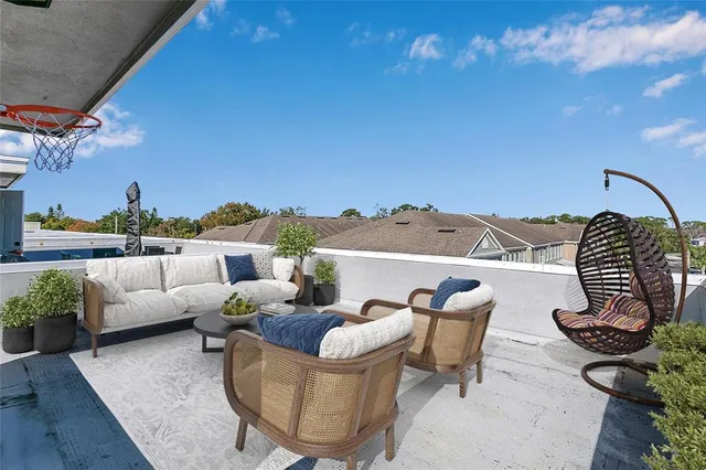 a view of a roof deck with couches and potted plants