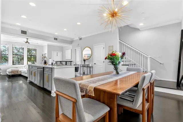 a view of a dining room with furniture and a chandelier