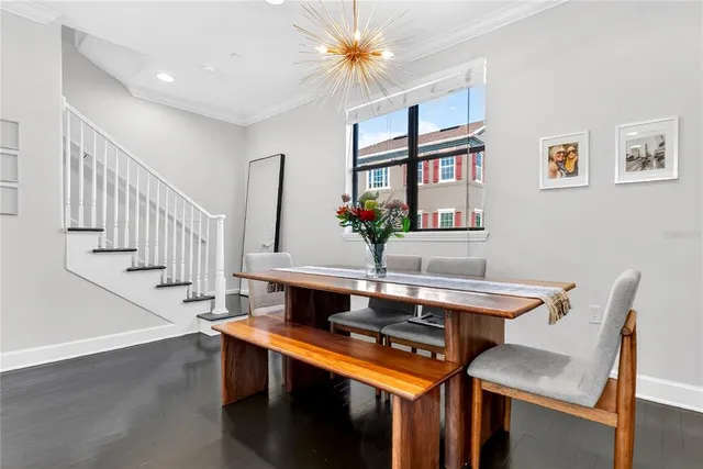 a view of a dining room with furniture and a chandelier