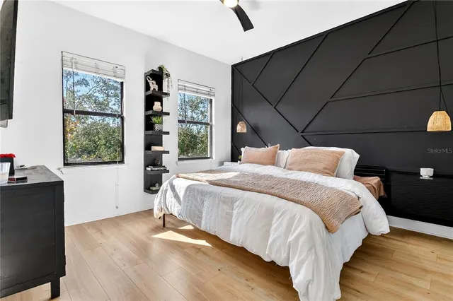 a bed sitting in a bedroom next to a window