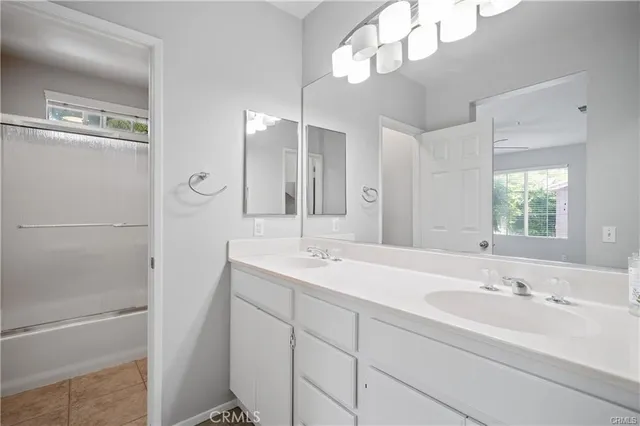 a bathroom with a sink a vanity a mirror and a shower
