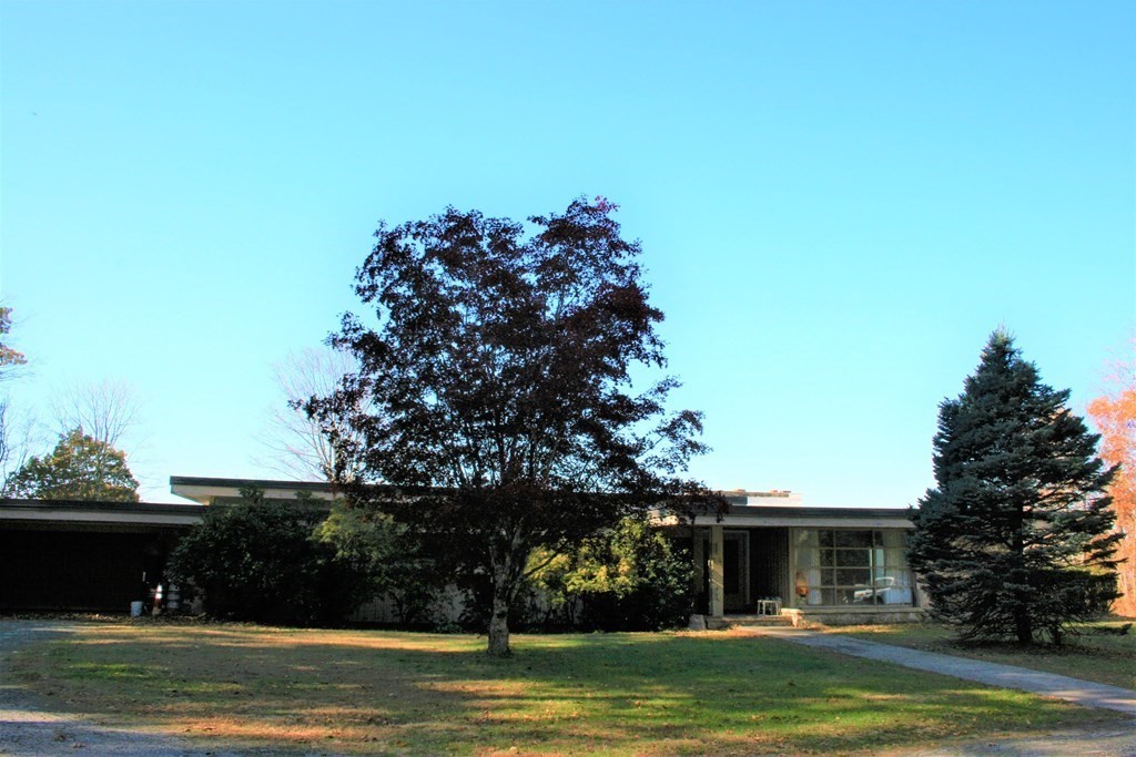 a front view of a house with a garden