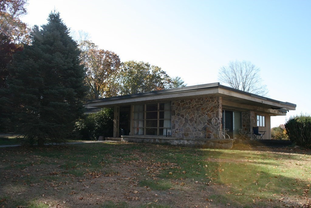 24 Sunset Rock Road Wilbraham, MA 01095 - Photo 2 of 18 a front view of house with yard and trees in the background