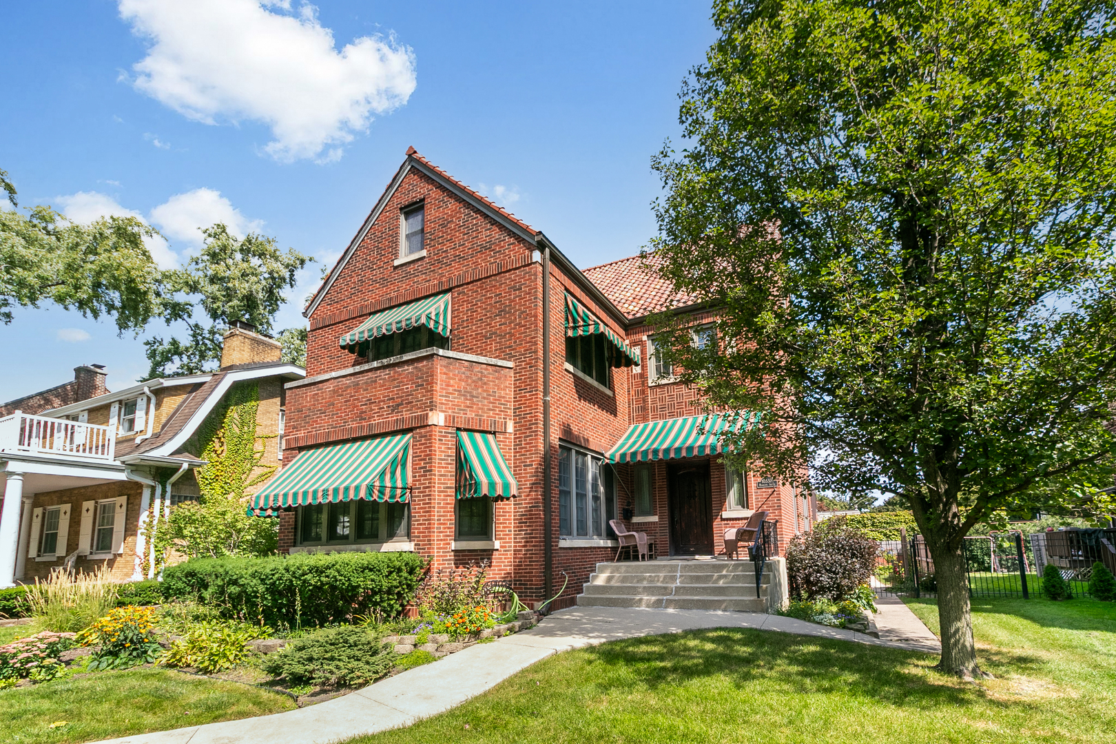 a view of a house with a yard and sitting area