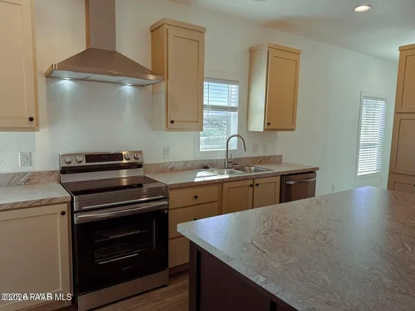 a kitchen with a stove and a sink
