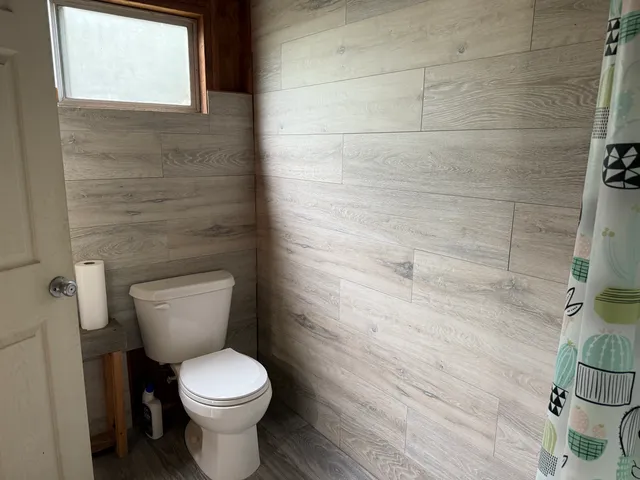 a white toilet sitting next to a white sink